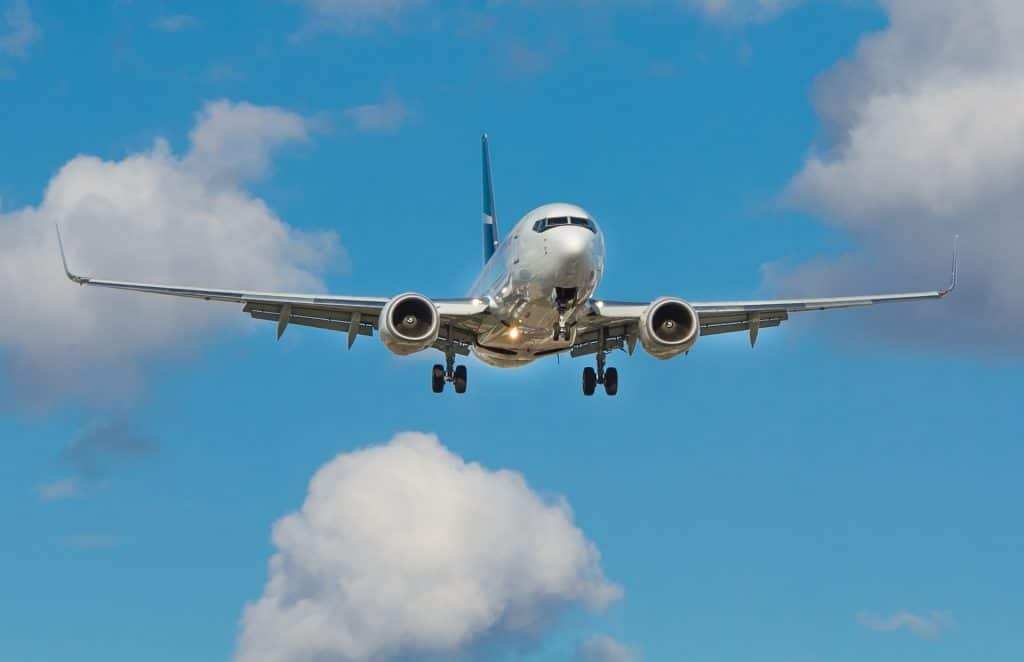 cheapest-days-to-book-flights-online-airplane-in-cloud-littered-skies