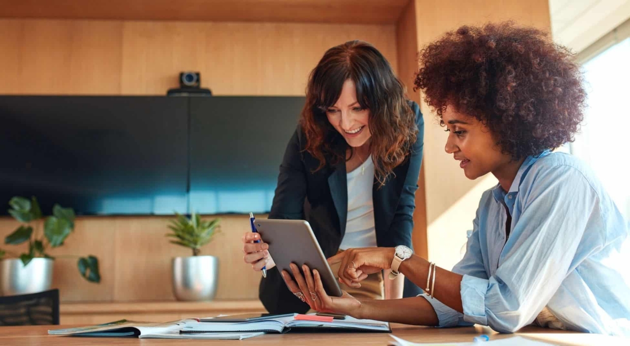 female colleagues looking at digital screen